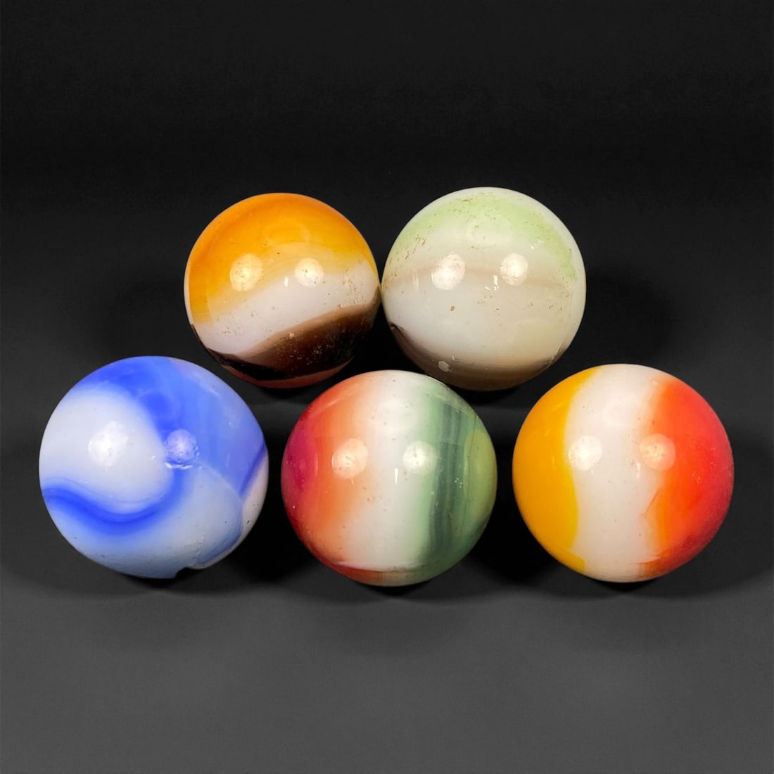 Vintage Glass Marbles Lot, Mid-20th Century, 1.5-1.6cm, 35EK: This charming lot of vintage glass marbles, dating from the mid-20th century, reflects the artistry and playfulness of early handmade and molded glass craftsmanship. These marbles were produced during