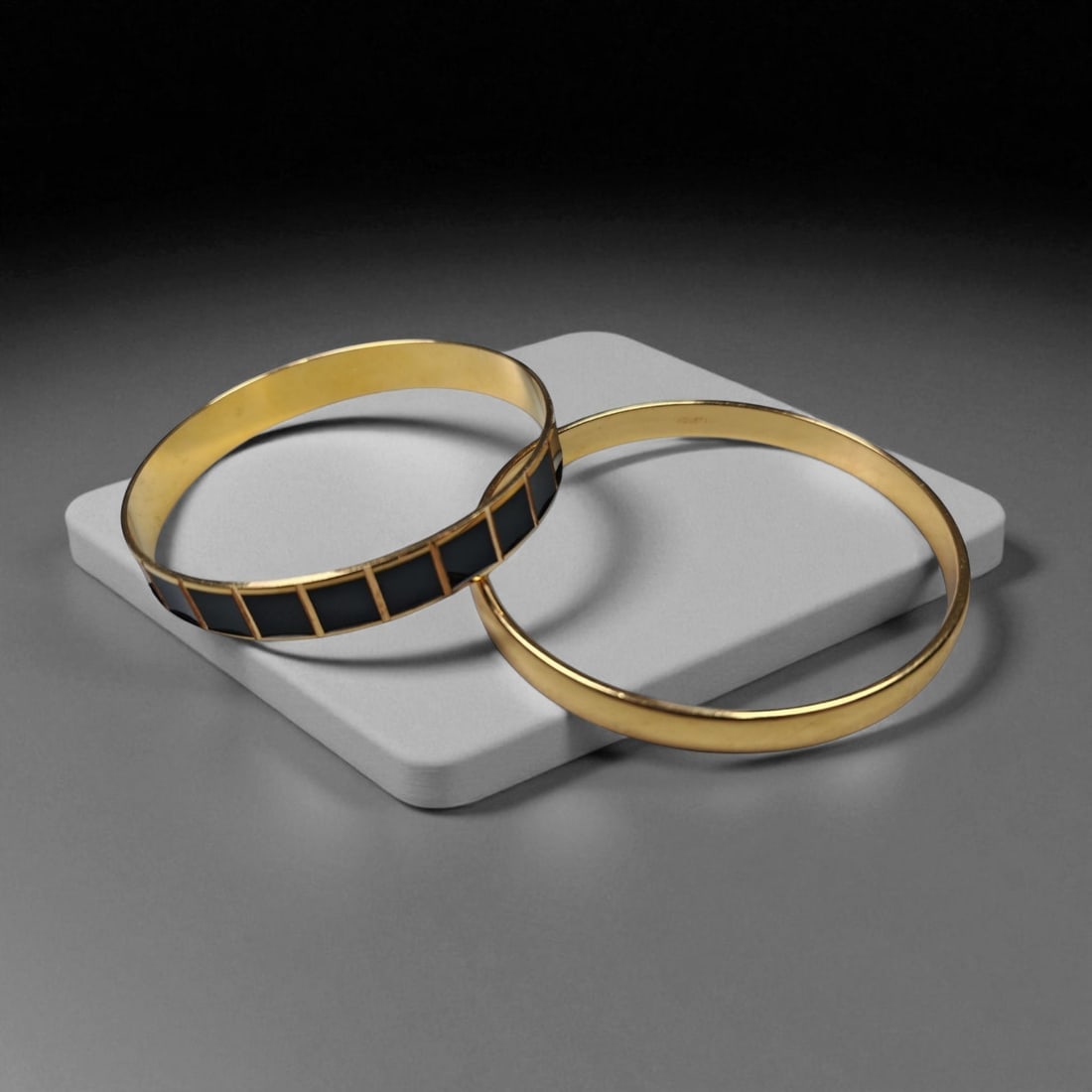 Set of Two Gold-Tone Bangles - Black Enamel and Classic Polished Design, 9WB: This sophisticated pair of gold-tone bangles combines minimalist elegance with refined vintage style. Measuring approximately 6.5 cm in diameter, the set presents a harmonious balance of texture and t
