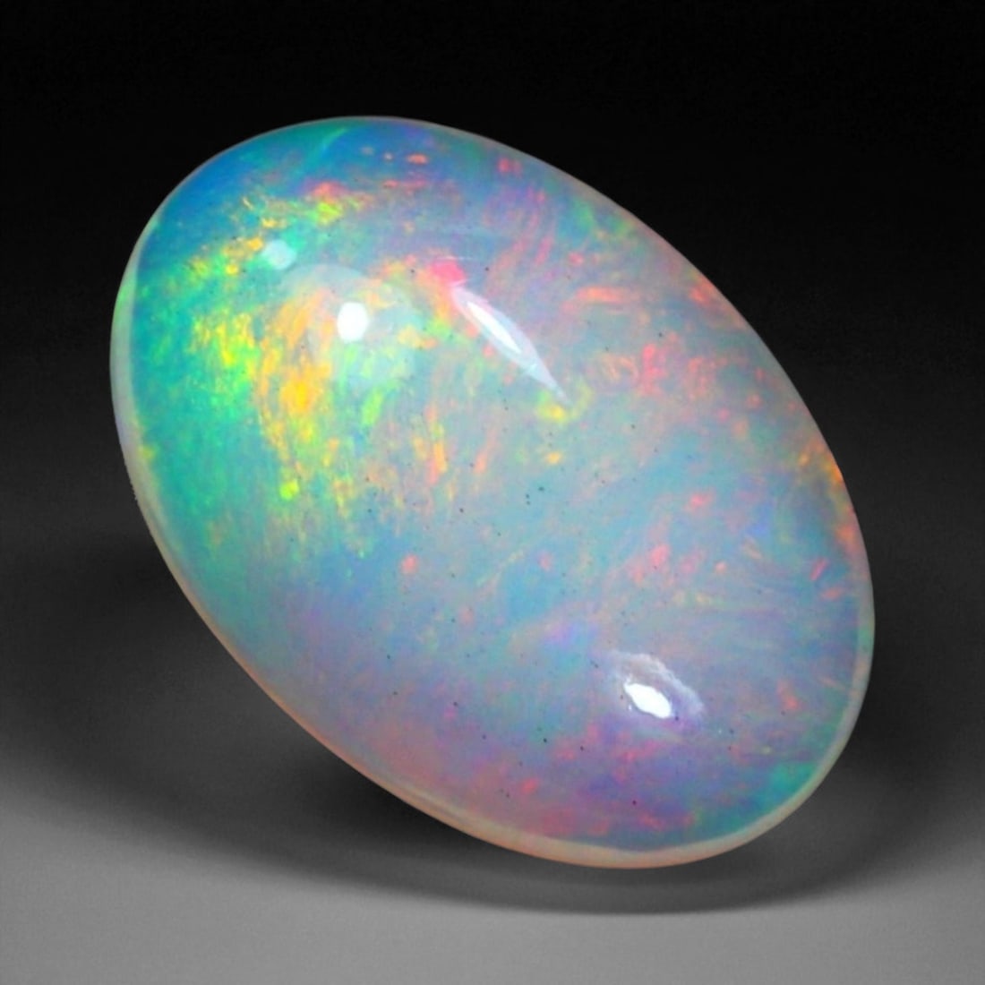 4.00 Carats Multi-Color Welo Opal Lot - Natural Ethiopian Stones, 82XB: This radiant group of Welo opals displays a mesmerizing interplay of color that dances across the surface with every shift of light. Electric flashes of green, orange, and red ripple through a translu