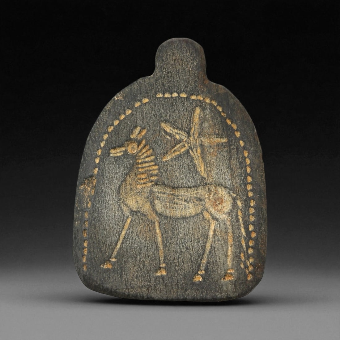 A Sasanian Engraved Steatite Amulet with Celestial Horse, c. 3rd-6th Century CE 9 x 6.5 cm, 74BF: This finely incised steatite amulet, measuring 9 x 6.5 cm, originates from the Sasanian Empire - the last great pre-Islamic Persian dynasty, renowned for its synthesis of royal symbolism and cosmic th