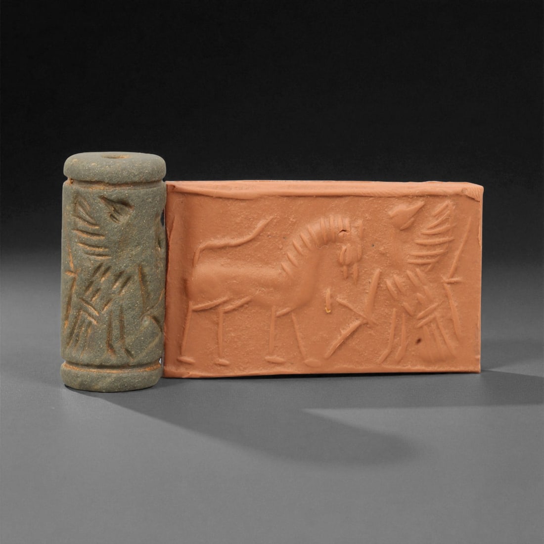 A Mesopotamian Cylinder Seal Depicting Processional Scene, c. 2nd-1st Millennium BCE, 3.9cm, 22M: A striking relic from the dawn of civilization, this A Mesopotamian cylinder seal dates to the 2nd-1st millennium BCE - a period when art, writing, and ritual became inseparable expressions of cultura