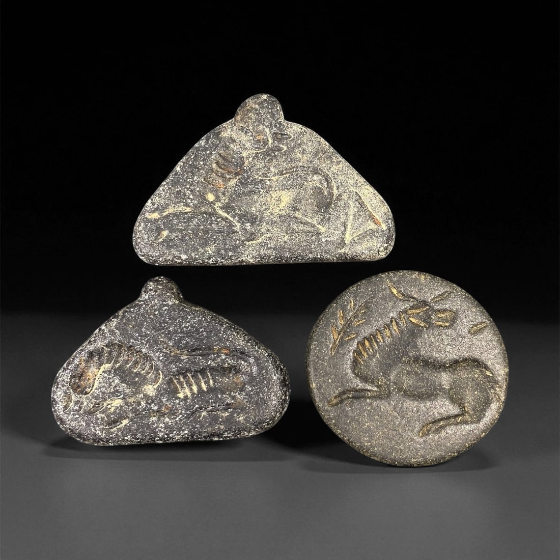 Ancient Neo-Assyrian Steatite Amulet Group, c. 8th-7th Century BCE, 4-4.5cm, 5EP: This rare assemblage of three carved steatite amulets originates from the Neo-Assyrian period, a pinnacle of Mesopotamian artistry renowned for its intricate symbolism and protective talismans. Each p