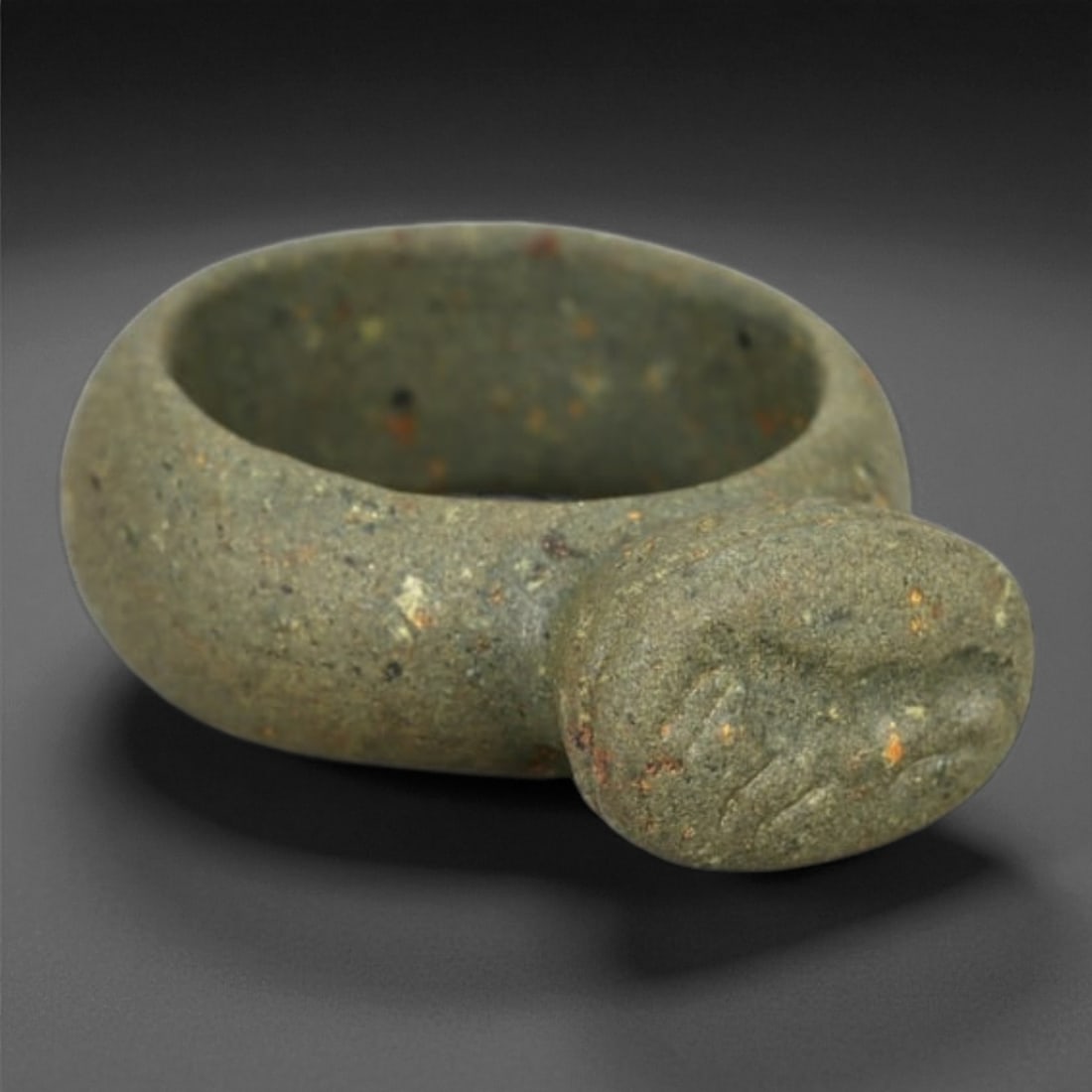 A Parthian Steatite Signet Ring with Feline Intaglio, 2nd-3rd Century CE, 5LG: Carved from grey-green steatite with small mineral inclusions, the ring is formed as a thick rounded band expanding into an oval bezel. The bezel bears a shallow intaglio depicting a stylized feline h