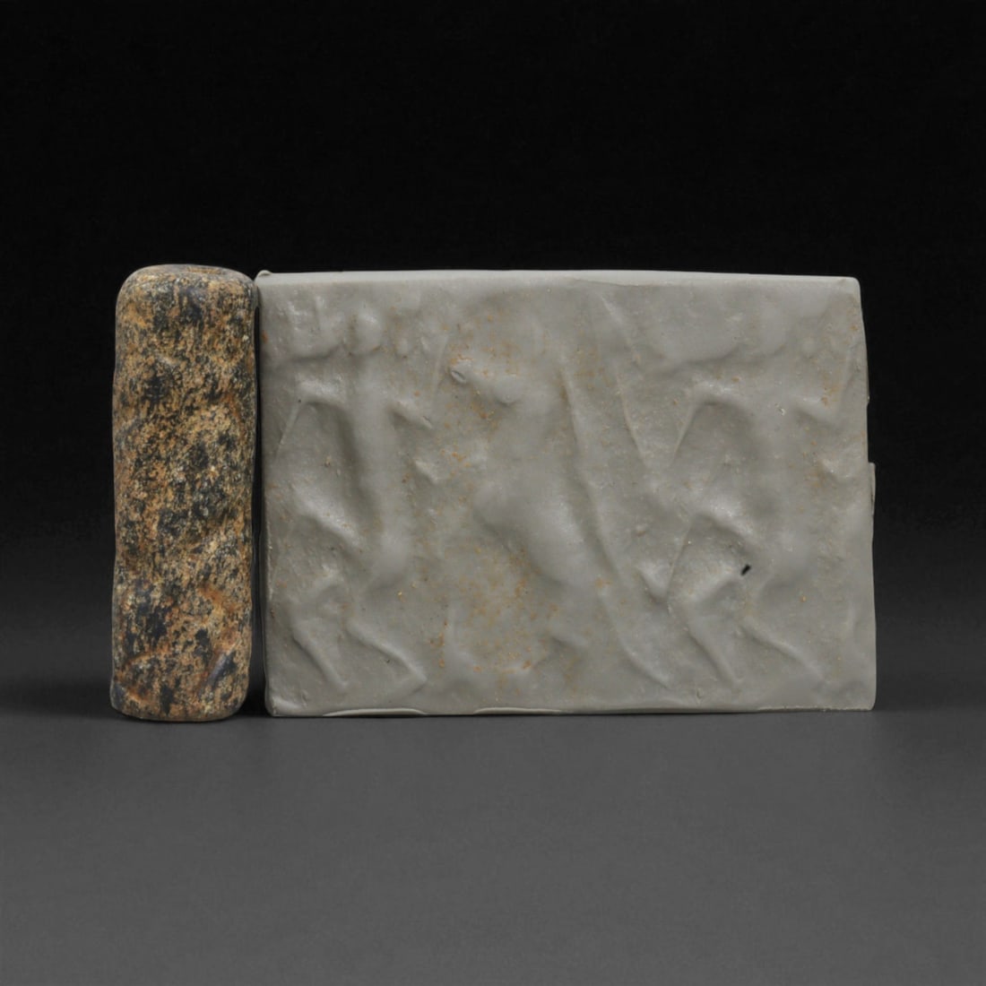 A Mesopotamian Stone Cylinder Seal, 3rd-2nd Millennium BCE, 3.5cm, 55BE: This authentic cylinder seal from ancient Mesopotamia dates to the 2nd to 1st millennium BCE, a time when the art of carving miniature narratives on stone reached remarkable levels of refinement. Seal