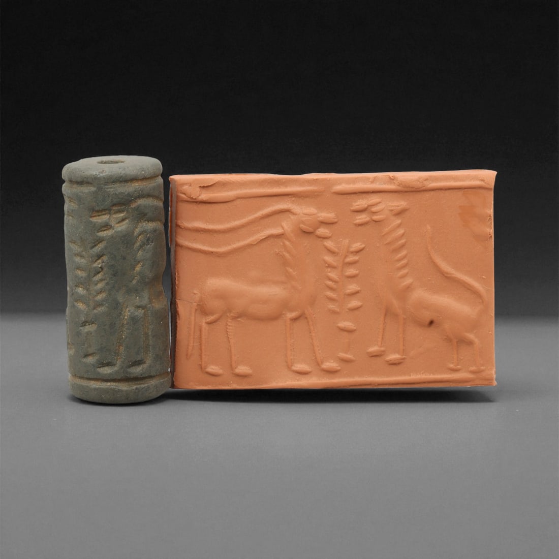 Ancient Mesopotamian Cylinder Seal of Divine Favor, c. 2nd-1st Millennium BCE, 4cm, 39M: A striking relic from the dawn of civilization, this ancient Mesopotamian cylinder seal dates to the 2nd-1st millennium BCE - a period when art, writing, and ritual became inseparable expressions of c