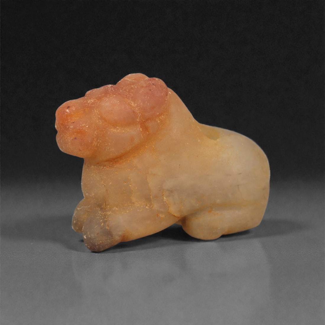 Ancient Akkadian Bull Basalt Amulet, c. 23rd-21st Century BCE 2.8cm, 94LG: This solid and expressive amulet, carved from dark basalt, depicts a stylized bull and dates to the Akkadian period of Mesopotamia, circa 23rd-21st century BCE. The bull, a central figure in Akkadian 