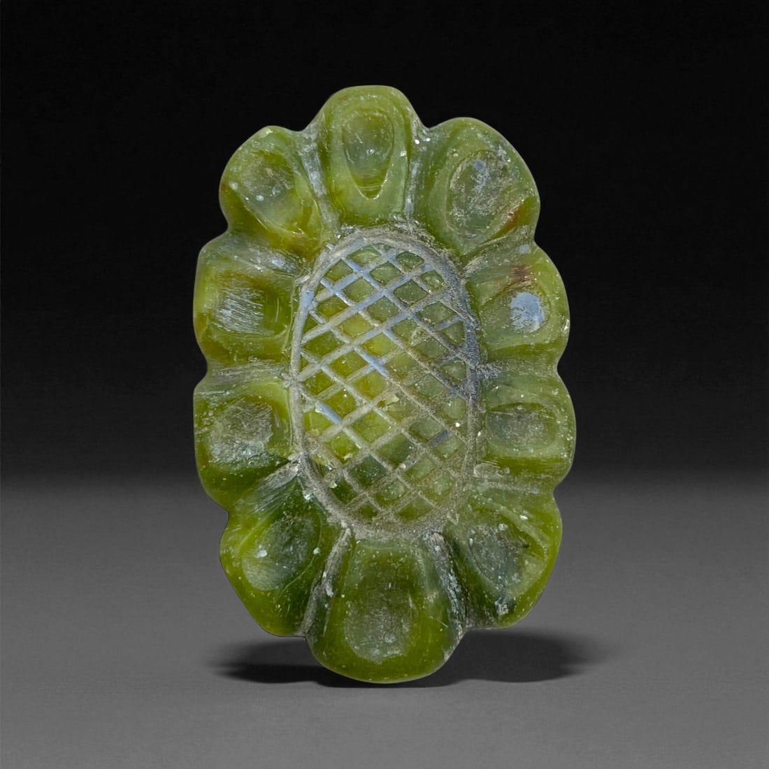 Ancient Achaemenid Green Chalcedony Floral Amulet Plaque, c. 5th-4th Century BCE, 5cm, 21g, 98DD: This elegant green chalcedony amulet plaque originates from the Achaemenid Persian Empire, a civilization celebrated for its refined artistry and profound symbolic language. The plaque's oval form, bo