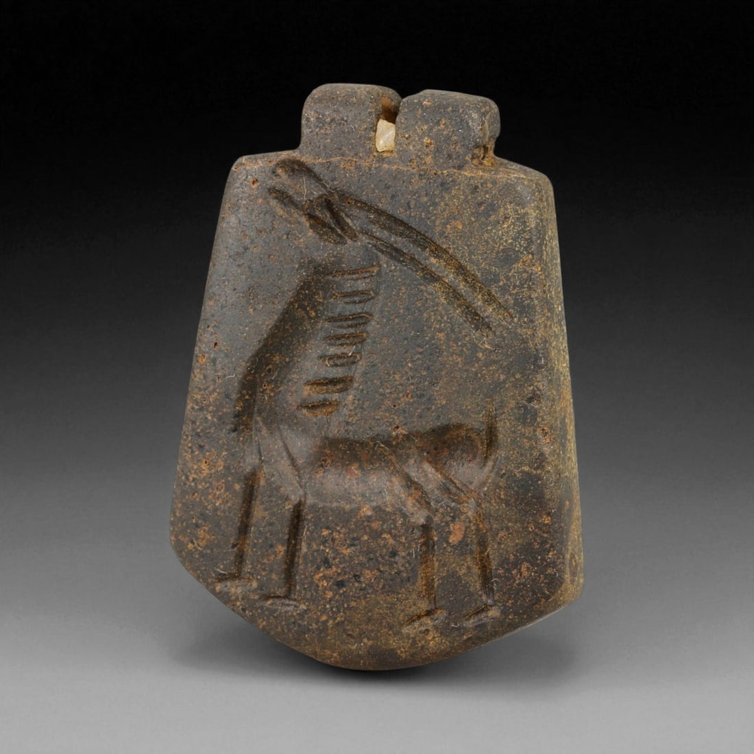 Ancient Neo-Babylonian Steatite Gazelle Motif Amulet Pendant, c. 7th-6th Century BCE 17g, 81BG: This pendant, carved from dark steatite and weighing 17 g at 4 cm, dates to the Neo-Babylonian period, c. 7th-6th century BCE. Pierced at the top for suspension, it was designed as a personal amulet t