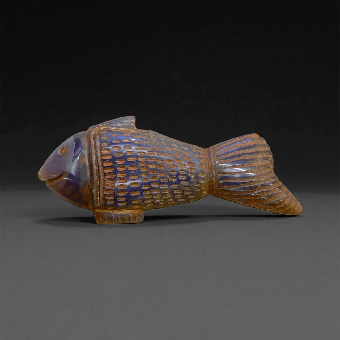 Ancient Medieval Islamic Chalcedony Fish Effigy, c. 11th-13th Century CE, 10cm, 65g, 65CC: This finely carved chalcedony fish effigy dates to the Islamic medieval period, circa 11th-13th century CE, reflecting the graceful synthesis of art, symbolism, and natural form characteristic of the 