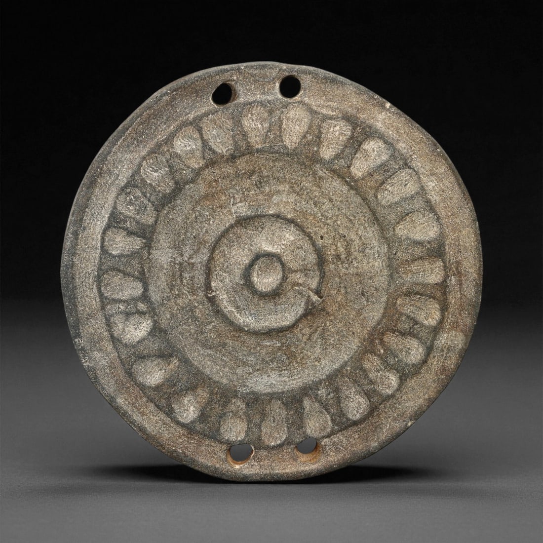Ancient Proto-Elamite Solar Rosette Steatite Round Plaque, c. 30th-27th Century BCE, 7.3cm, 10ES: This circular steatite plaque from the Proto-Elamite period of southwestern Iran presents an abstract yet profoundly symbolic design centered on the solar rosette - one of humanity's earliest visual e