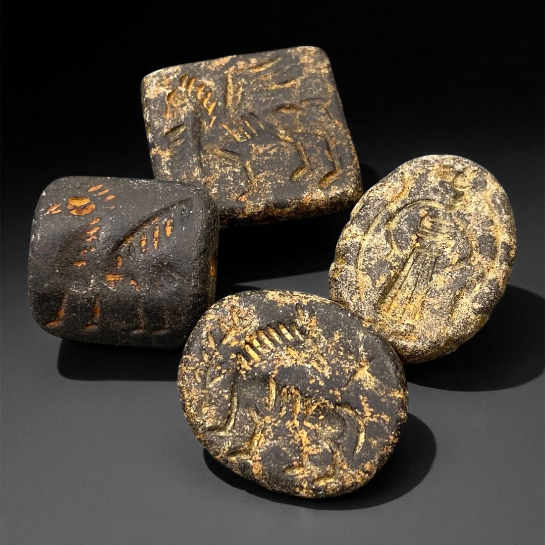 Ancient Neo-Sumerian Steatite Stamp Seal Group, c. 21st-20th Century BCE, 2.3-3cm, 88EK: This impressive group of four carved steatite stamp seals dates to the Neo-Sumerian period, a flourishing era of artistic refinement and administrative precision in ancient Mesopotamia. Each seal feat