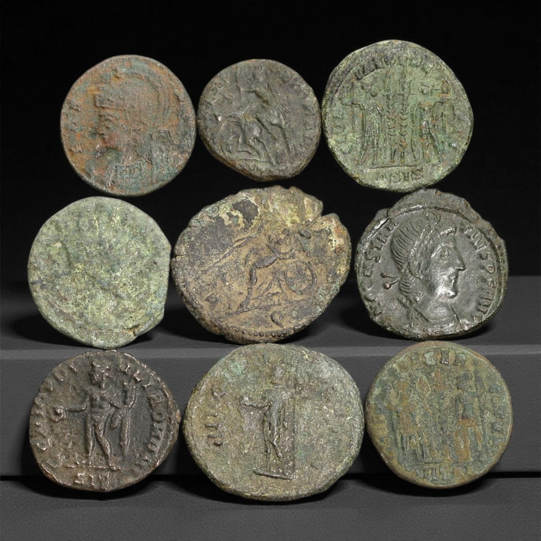 Ancient Roman Imperial Bronze Coins (AE2-AE3 Denominations), c. 3rd-4th Century CE, 64ER: A well-preserved group of nine bronze coins dating from the late Roman Imperial era, spanning approximately the 3rd to 4th century CE. These AE2-AE3 denominations represent a dynamic period of transit