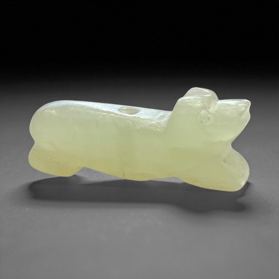 Pre-Columbian Mesoamerican Jade Zoomorphic Amulet, c. 900-1500 CE, 4.5cm, 15g, 30AA: This finely carved jade zoomorphic amulet, dating from approximately 900-1500 CE, embodies the artistic and spiritual sophistication of the Pre-Columbian Mesoamerican world. Rendered in pale green jad