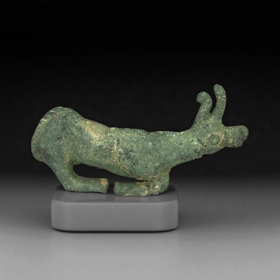 Ancient Scytho-Siberian Bronze Stag Plaque, c. 7th-5th Century BCE, 8.5cm, 44BF: This bronze plaque depicts a stylized stag in profile, crafted during the Scytho-Siberian period of the early Iron Age (7th-5th century BCE). Such zoomorphic ornaments were emblematic of the nomadic c