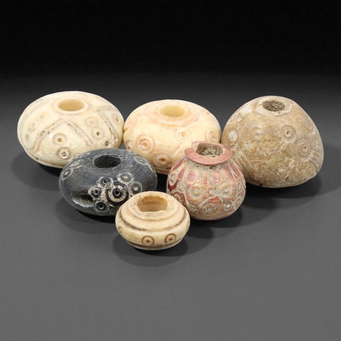 Ancient Near Eastern Bone Spindle Whorl c. 1st Mill BCE 1.2-1.8cm, 58ER: This ancient bone spindle whorl reflects the textile traditions that flourished across the Near East during the 1st millennium BCE, when finely made spinning tools were essential to daily life and oft