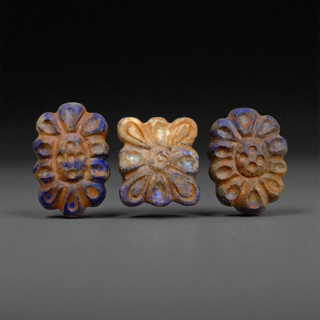 Ancient Achaemenid Lapis Lazuli Floral Bead Set, c. 6th-4th Century BCE 2.5-3cm 24g, 29BB: This refined set of three floral beads originates from the Achaemenid Persian Empire, c. 6th-4th century BCE, a civilization that elevated geometry and symbolism into a visual language of divine harmo