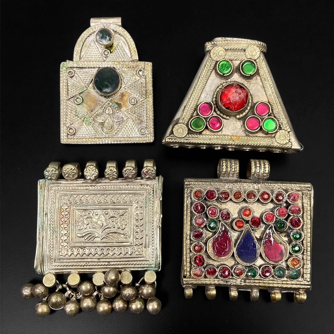 Antique Himalayan Silver Alloy Amulet Box Pendants Set, c. 19th-20th Century, 3.8-5.7 cm, 63EC: This captivating set of four antique Himalayan amulet boxes, dating to the 19th-20th century, represents the region's deep spiritual and artistic heritage. Crafted in silver alloy and richly adorned w