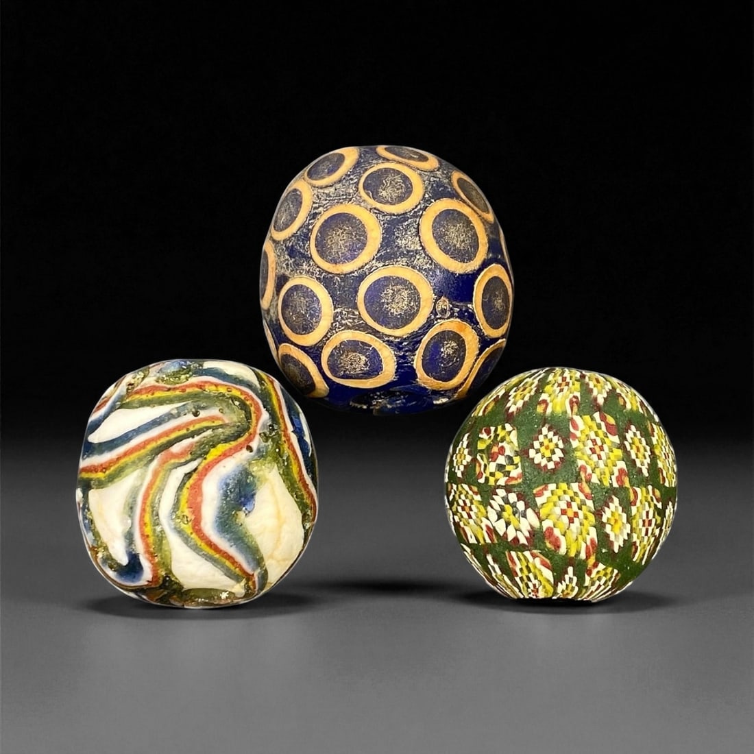 Ancient Majapahit Borneo Polychrome Glass Trade Beads, c. 13th-16th Century CE, 2-2.3cm, 30EF: These vibrant polychrome glass trade beads date to the Majapahit period of Southeast Asia, between the 13th and 16th centuries CE. Crafted with exquisite layered glasswork, each bead showcases intrica