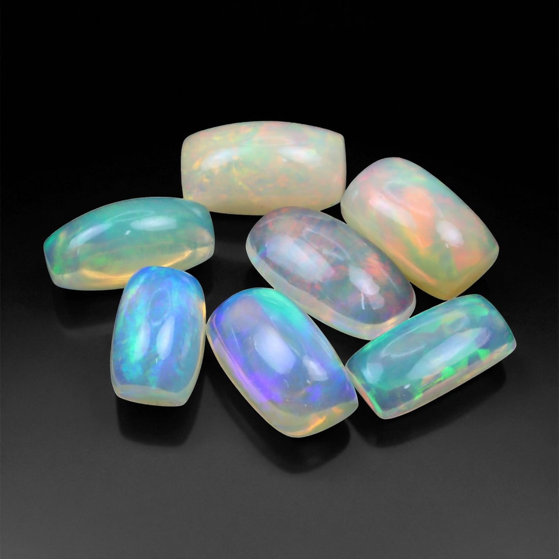 9.25 Carats Neon Play-of-Color Opal Selection - Natural Ethiopian Cabochons - 8 to 10 mm, 22XE: This luminous selection of opals radiates a dynamic spectrum of neon hues, with flashes of electric green, vivid orange, and spectral blue dancing across each dome. Their translucent base allows the i