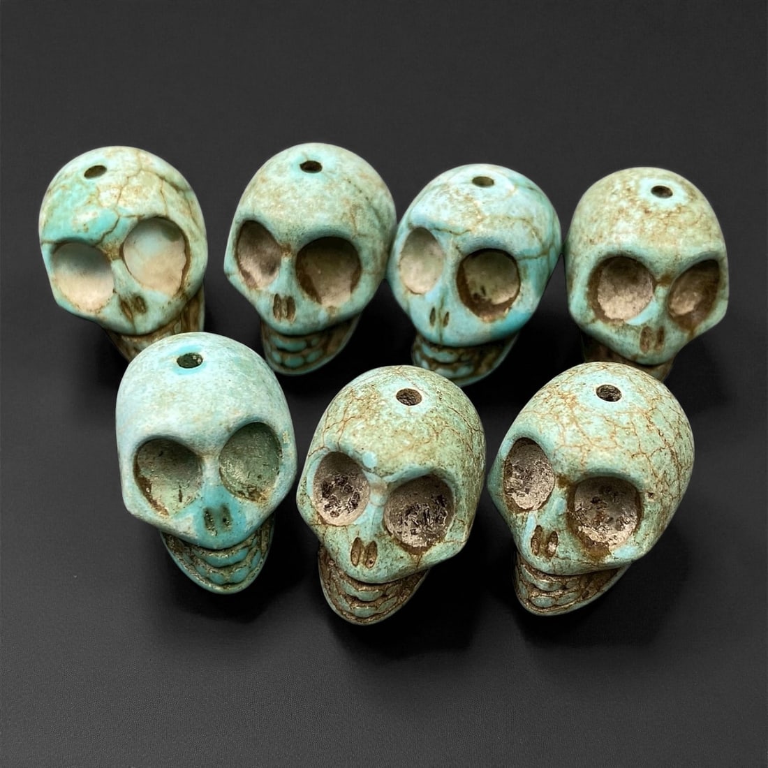 Vintage Tibetan Turquoise Skull Beads, c. Mid-20th Century, 1.7cm, 86EN: This striking set of turquoise-carved skull beads, originates from Tibet and dates to the mid-20th century. Finely shaped and perforated for stringing, each bead represents a human skull, a motif rich
