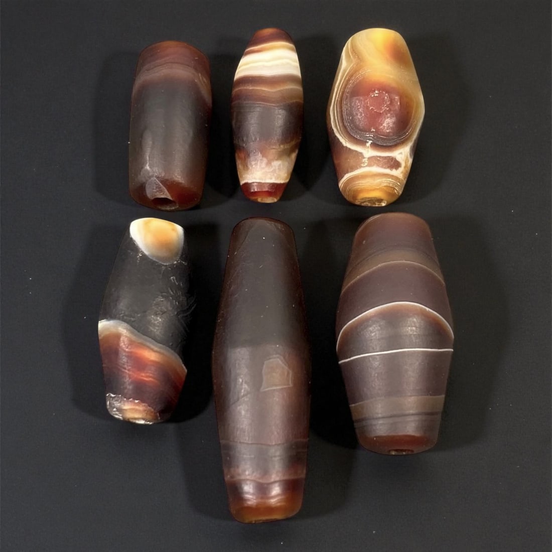 Ancient Persian Banded Agate Barrel Beads, c. 5th-3rd Century BCE, 1.9-3.1cm, 25EN: These elegant ancient Persian agate beads date to the Achaemenid to early Parthian period, circa 5th-3rd century BCE. Expertly shaped into elongated barrel forms, each bead displays the natural bandin
