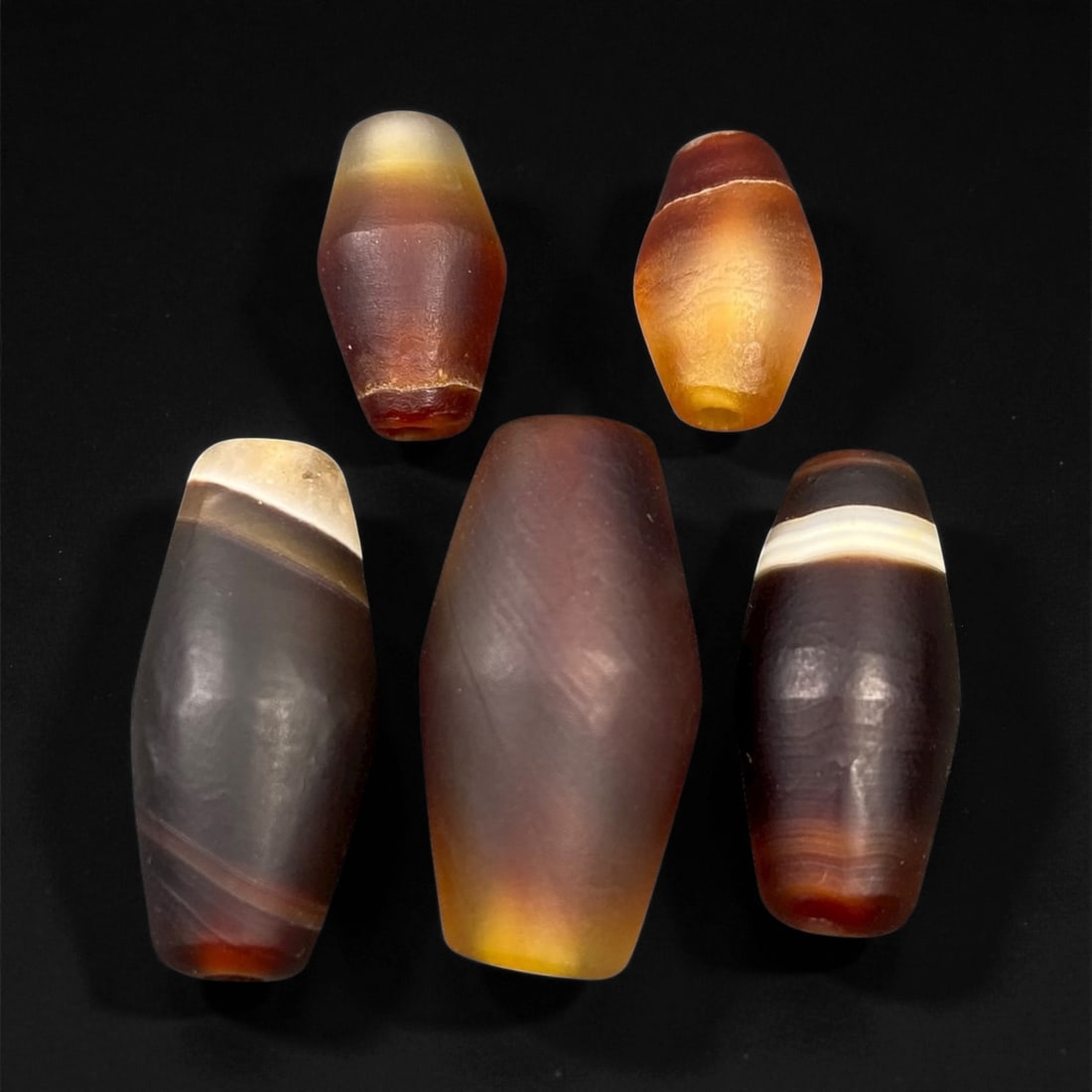 Ancient Persian Banded Agate Barrel Beads, c. 5th-3rd Century BCE, 1.5-2.6cm, 39EN: These elegant ancient Persian agate beads date to the Achaemenid to early Parthian period, circa 5th-3rd century BCE. Expertly shaped into elongated barrel forms, each bead displays the natural bandin