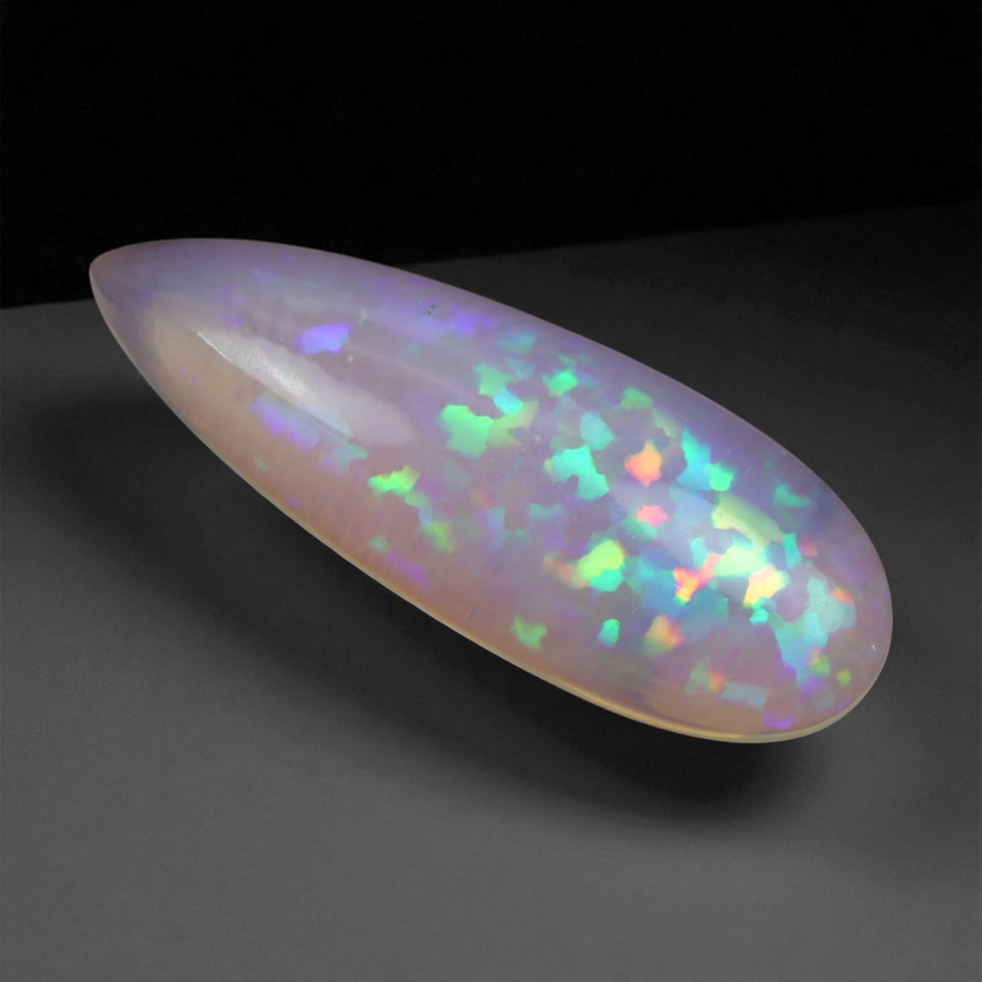 5.77 Carats Multicolor Opal Selection - Natural Welo Ethiopian Stones, 30XB: This luminous selection of Welo opals dazzles with vibrant play-of-color, ranging from electric greens and cobalt blues to sunlit oranges and flashes of violet. Each cabochon has been hand-selected fo