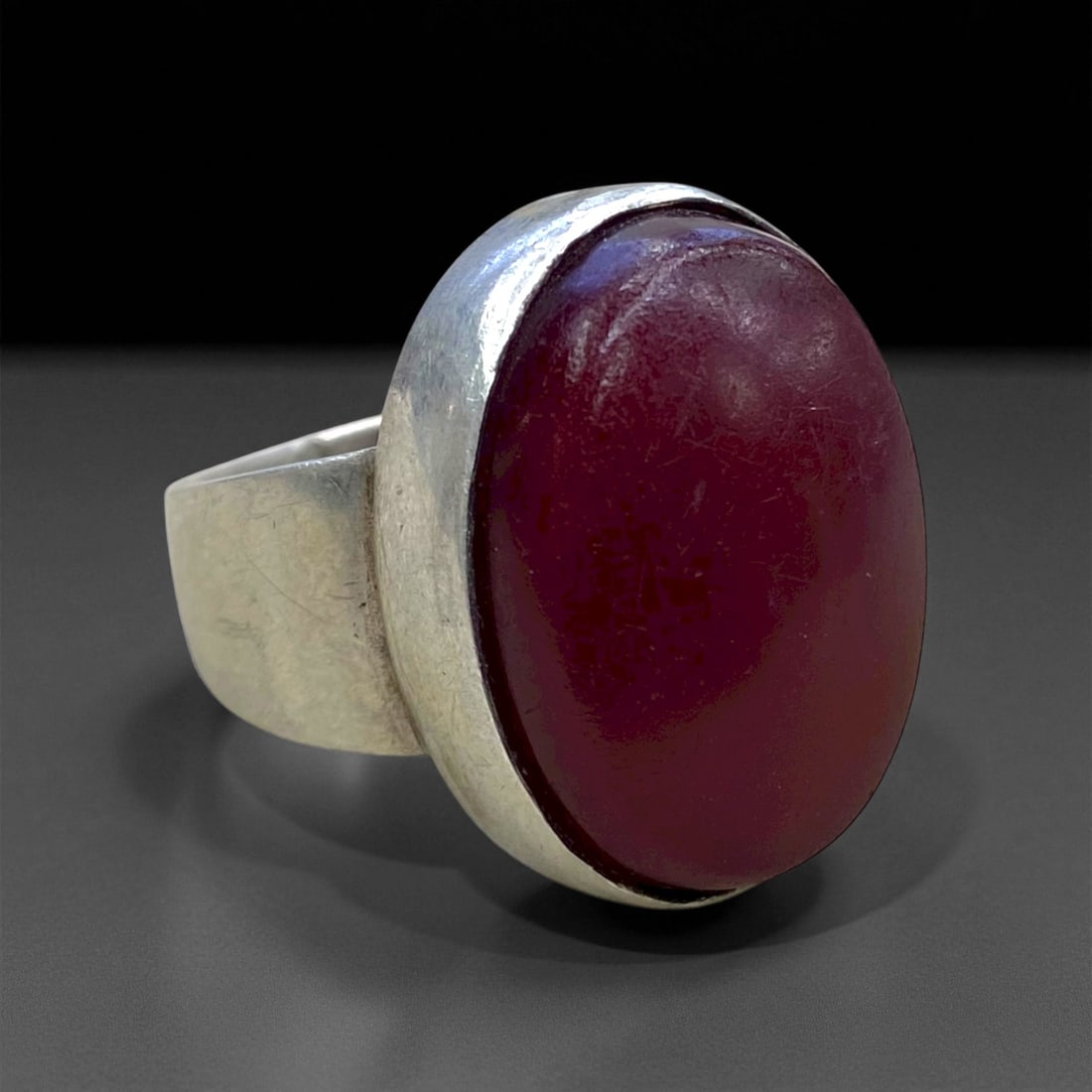 Antique Persian Red Agate Cabochon Silver Ring, c.19th-Early 20th Century, Size 9.5, 14.6g, 37CC: This commanding antique silver ring reflects the minimalist strength of late Qajar-era Persian design, where simplicity itself became an emblem of dignity and power. Set with a large oval red agate ca