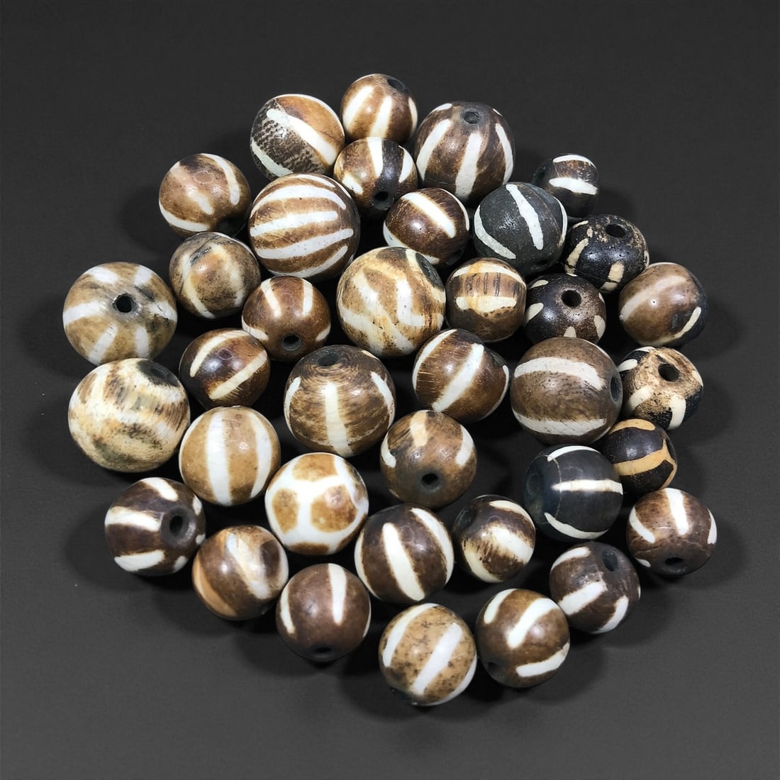Antique Burmese Pumtek Patterned Wood Beads c. 18th-19th Century 1.2-1.7cm, 81ER: These antique Pumtek beads originate from the cultural traditions of Burma, where patterned wood beads continued to hold symbolic and decorative significance throughout the 18th-19th century. Crafted 