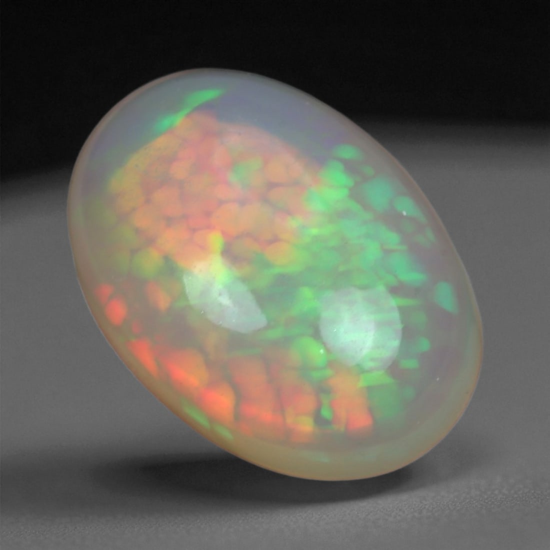 4.59 Carats Multicolor Opal Selection - Natural Welo Ethiopian Stones, 33XB: This luminous selection of Welo opals dazzles with vibrant play-of-color, ranging from electric greens and cobalt blues to sunlit oranges and flashes of violet. Each cabochon has been hand-selected fo