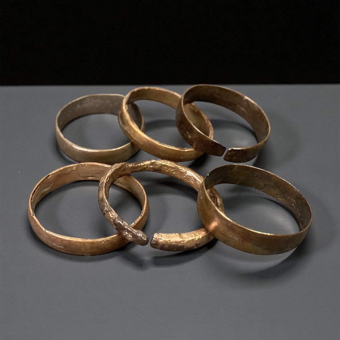 Ancient Medieval European Bronze Band Rings, c. 12th-15th Century CE, US 8.5-10.25, 45EP: This group of six bronze band rings dates from the 12th-15th century CE, representing the understated elegance of medieval European personal adornment. Each ring is forged from bronze and shaped into