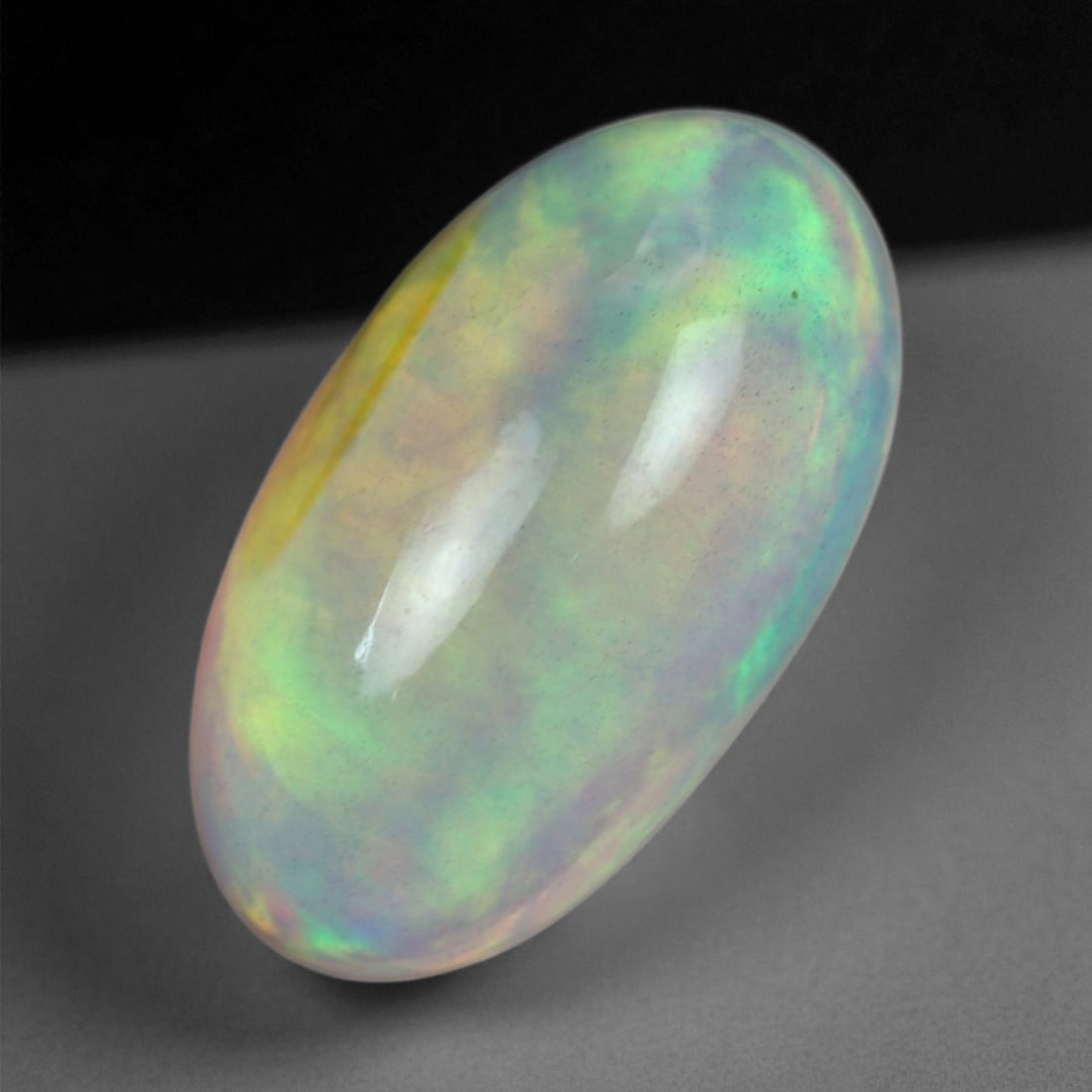 5.42 Carats Multicolor Opal Selection - Natural Welo Ethiopian Stones, 16XB: This luminous selection of Welo opals dazzles with vibrant play-of-color, ranging from electric greens and cobalt blues to sunlit oranges and flashes of violet. Each cabochon has been hand-selected fo