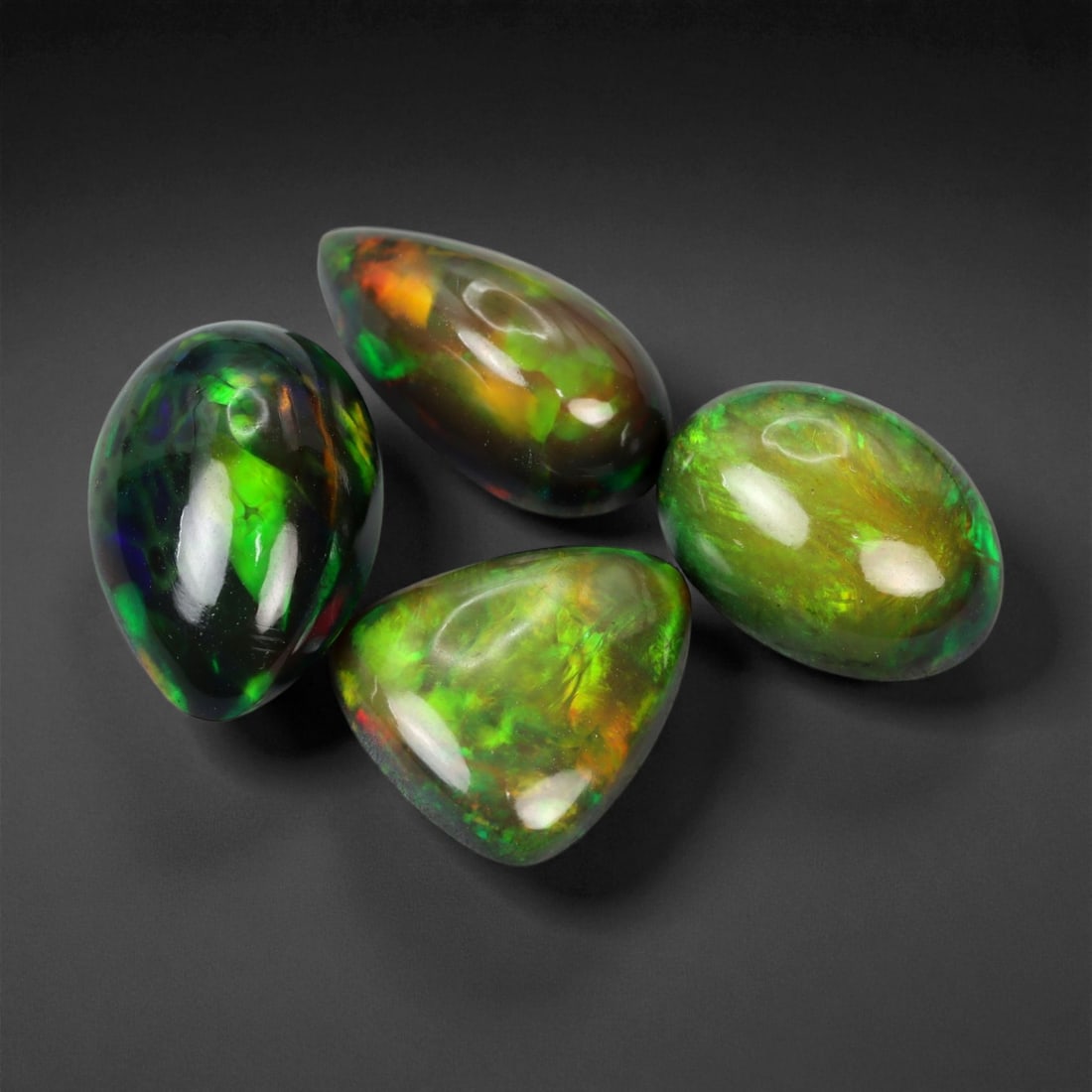 9.34 Carats Fiery Black Opal Selection - Natural Ethiopian Cabochons - 10 to 13 mm, 20XE: This dramatic selection of black opals captivates with intense flashes of crimson, emerald, and molten orange, all set against deep, inky body tones that amplify their internal fire. Each stone displa