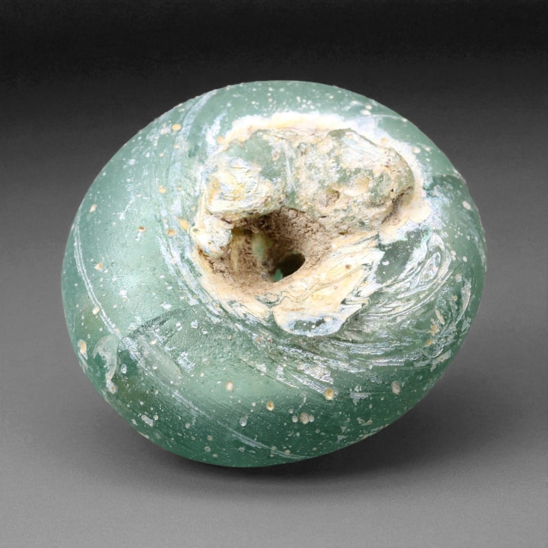 Ancient Mesopotamian Emerald Green Glass Bead, c. 8th-5th Century BCE, 2.5cm, 7.2g, 84M: This captivating emerald green glass bead, with its luminous surface and striking domed form, hails from the heart of the ancient Mesopotamian world-where glassmaking first flourished as both science 