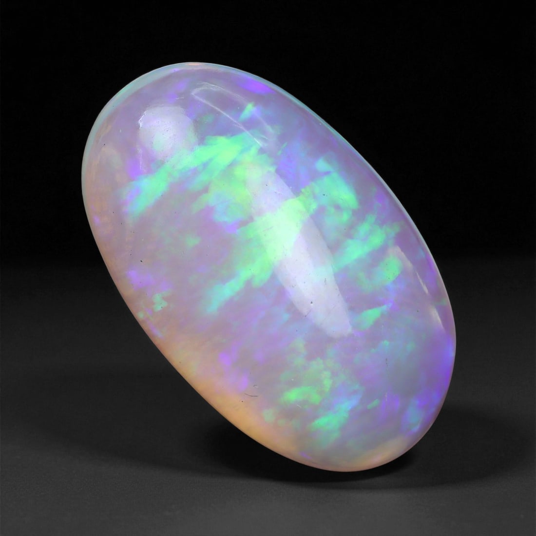 3.68 Carats Pastel Neon Welo Opal Cabochon - Natural Ethiopian Gemstone, 93XE: This glowing Welo opal shimmers with delicate flashes of mint green, lavender, sky blue, and soft amber beneath a translucent, honey-toned body. Its internal light play is gentle yet vivid, with broad
