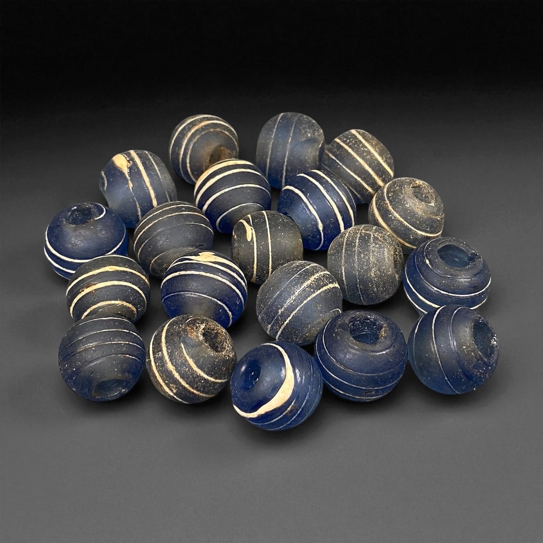 Antique Indo-Pacific Blue Glass Eye Beads, c. 18th-19th Century 1.3 cm, 6ED: These antique blue glass beads, dating to the 18th-19th century, represent the enduring craftsmanship of Indo-Pacific glassmaking traditions that flourished along ancient maritime trade routes. Their 