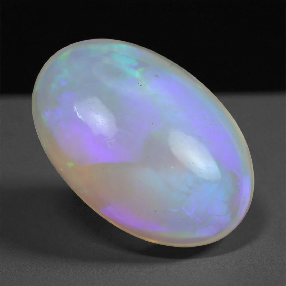 5.47 Carats Multicolor Opal Selection - Natural Welo Ethiopian Stones, 80XB: This luminous selection of Welo opals dazzles with vibrant play-of-color, ranging from electric greens and cobalt blues to sunlit oranges and flashes of violet. Each cabochon has been hand-selected fo