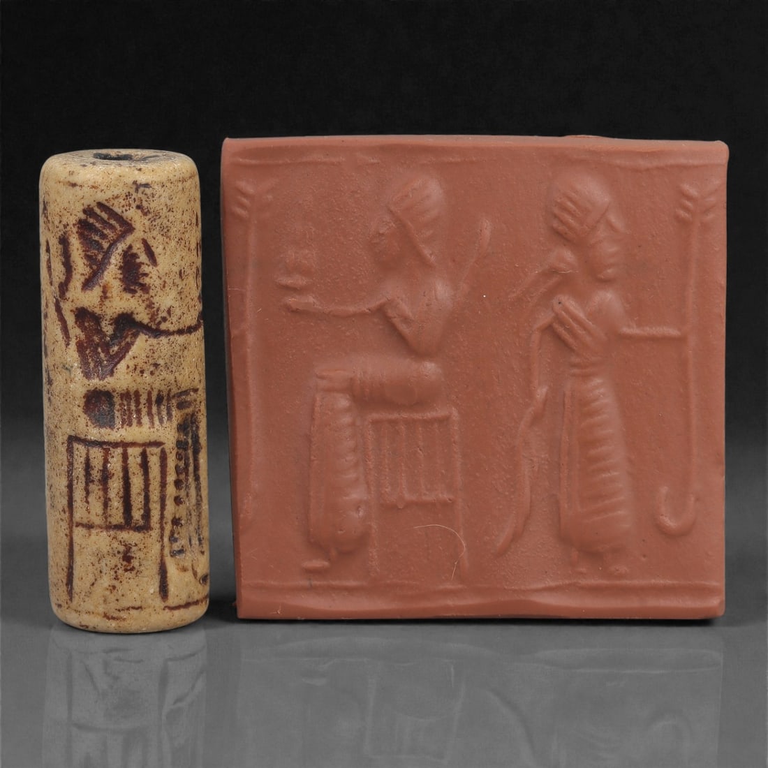A Near Eastern Stone Cylinder Seal, 3rd Millennium BCE, 4.4cm, 28LM: Carved from stone with darker surface mottling, the cylindrical seal bears a continuous engraved scene. The carving is executed in shallow linear grooves typical of Early Bronze Age glyptic traditions