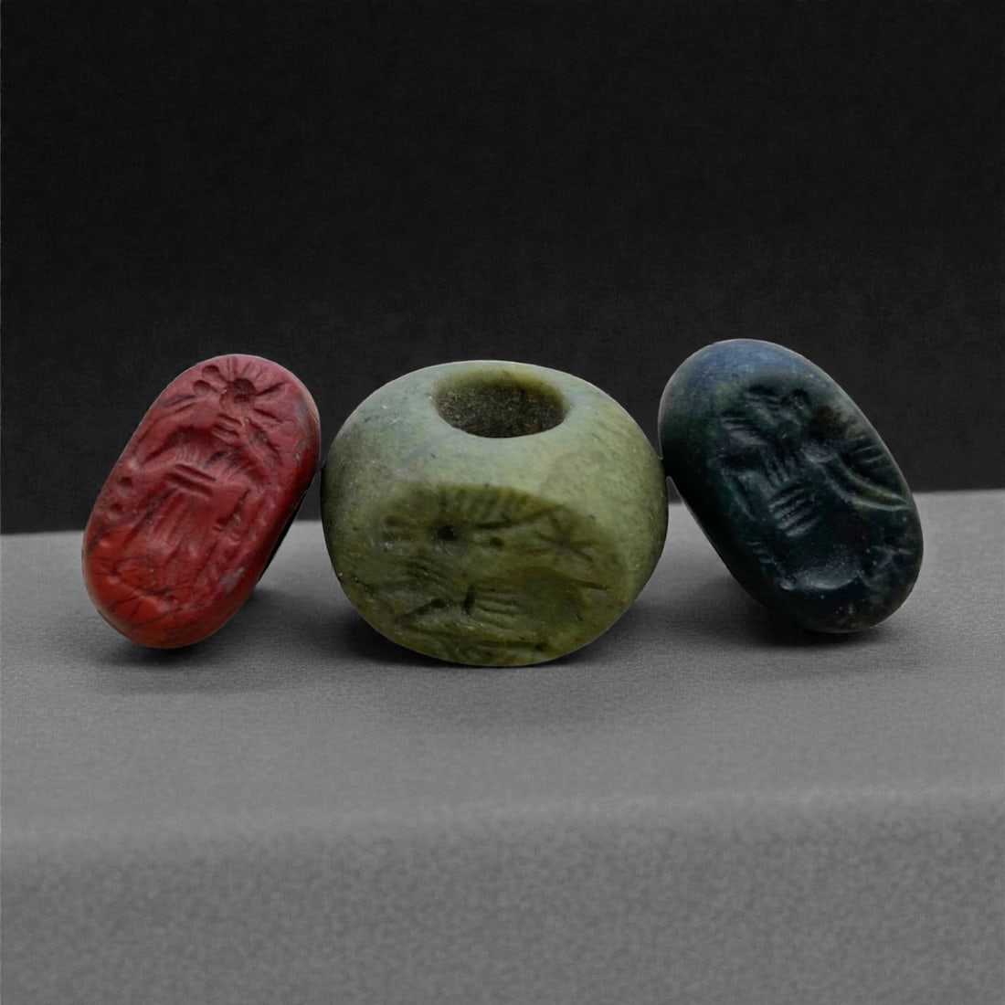 A Sasanian Hemispherical Jasper and Steatite Stamp Seals, c. 3rd-6th Century CE, 1.5-2 cm 15g, 99BB: This distinguished group of A Sasanian hemispherical stamp seals, carved from deep green steatite and richly hued jasper, represents the refined artistry and religious symbolism of Persia's late A emp