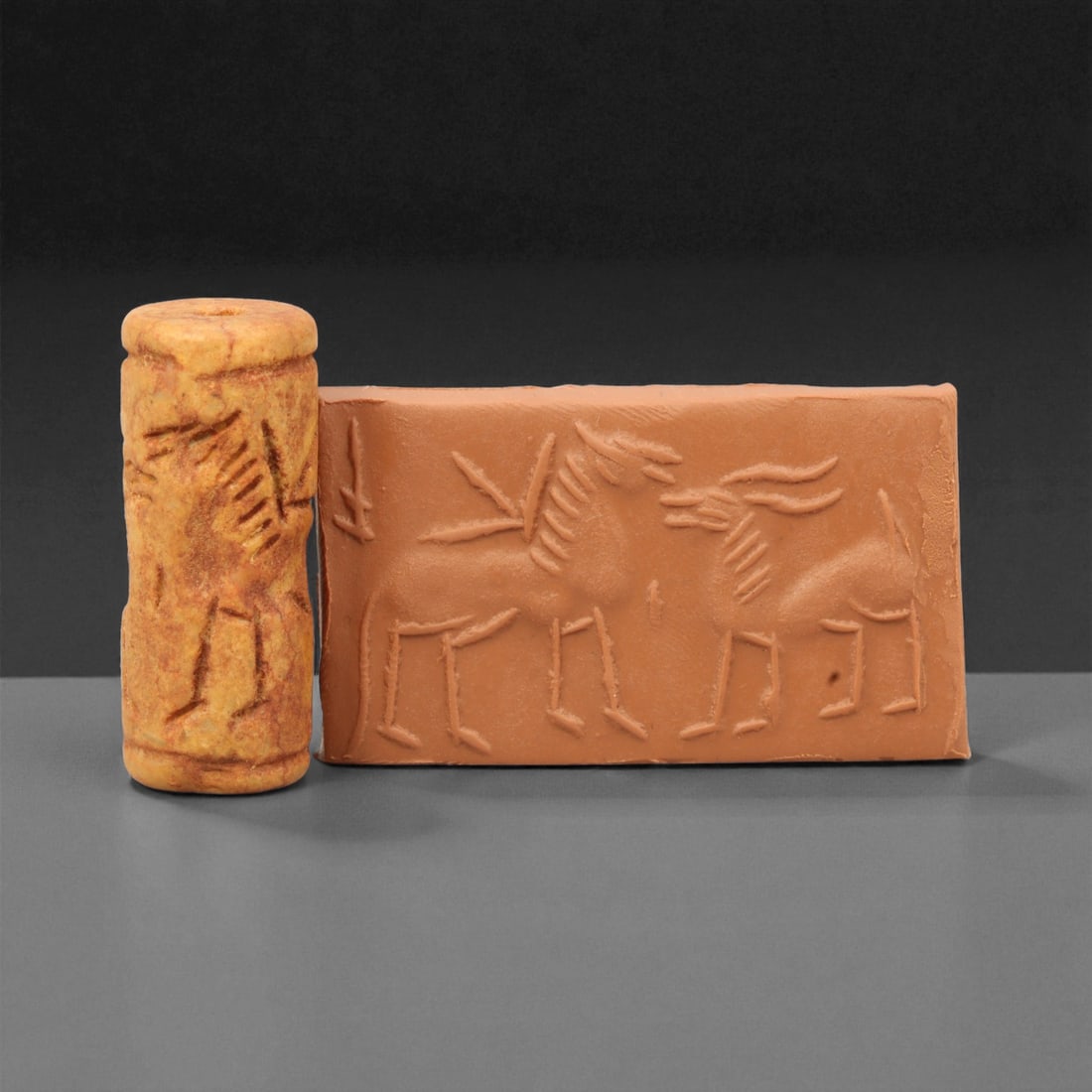 A Mesopotamian Stone Cylinder Seal, 3rd-2nd Millennium BCE, 4cm, 48M: This Mesopotamian cylinder seal dates to the 2nd-1st millennium BCE. Carved from stone, it would have been used to roll designs onto wet clay as a mark of ownership or identification. The seal fits co