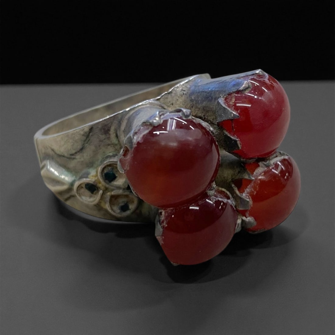 Antique Caucasian Silver and Carnelian Cluster Ring, c. 19th Century, US 9 10g, 86BB: This striking antique ring captures the exuberant spirit of 19th-century Caucasian jewelry, where bold design met symbolic craftsmanship. Fashioned in solid silver, the ring features a cluster of four