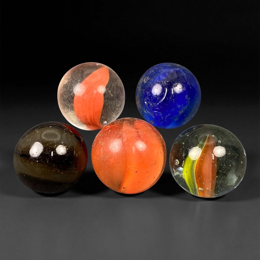 Vintage Glass Marbles Lot, Mid-20th Century, 1.5-1.6cm, 5EN: This charming lot of vintage glass marbles, dating from the mid-20th century, reflects the artistry and playfulness of early handmade and molded glass craftsmanship. These marbles were produced during