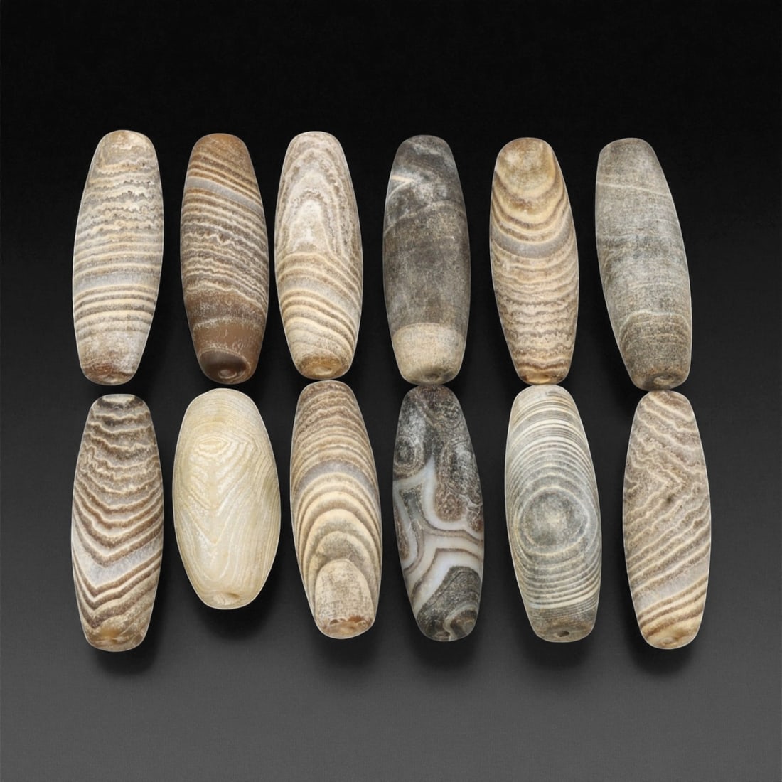 Ancient Medieval Tibetan Chung Dzi Agate Beads, c. 14th-16th Century CE, 2.5-3cm, 7EF: This harmonious group of Chung Dzi agate beads dates to the late medieval period of Tibet, approximately the 14th-16th century CE. Each bead exhibits natural banding in muted tones of cream, beige, an