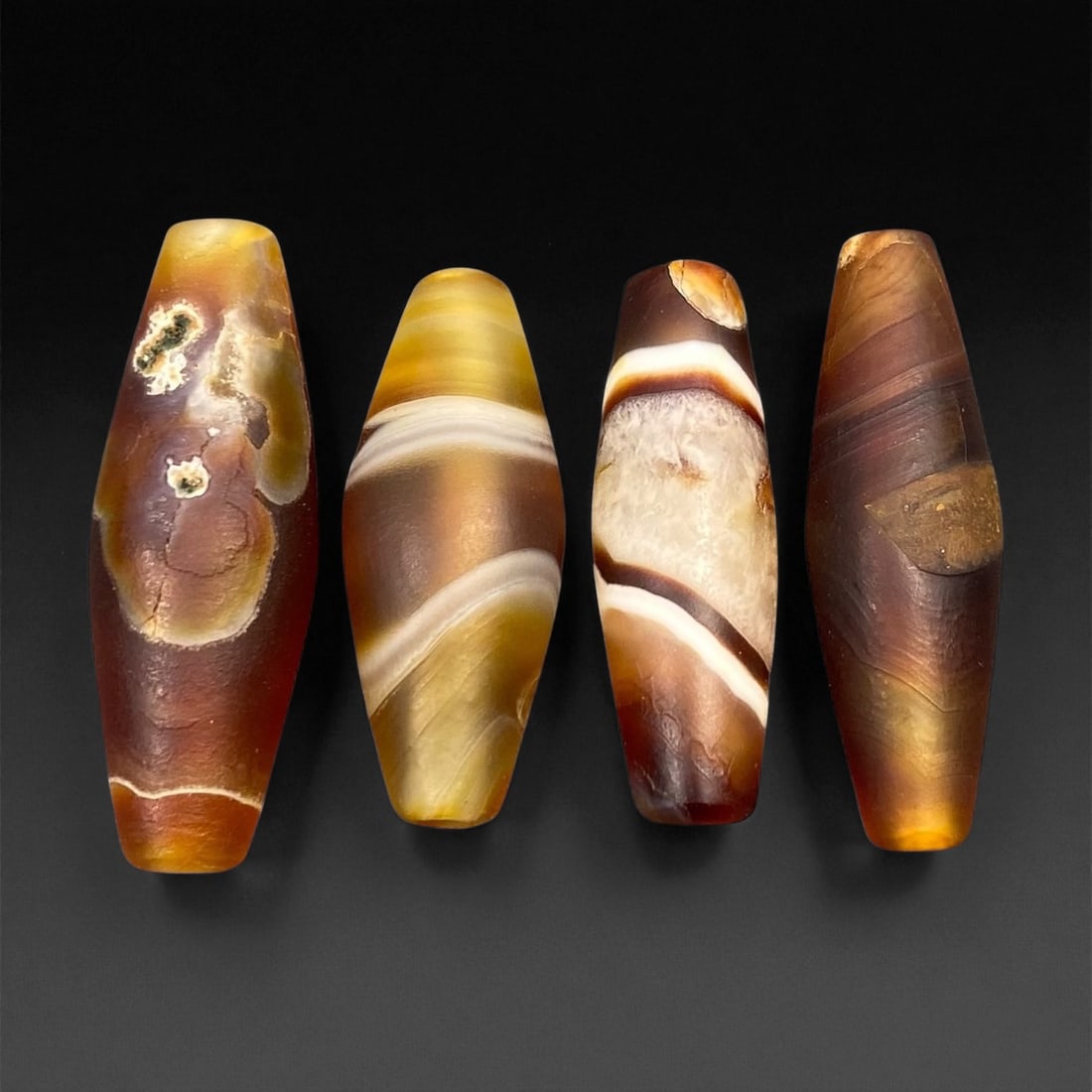 Ancient Persian Banded Agate Barrel Beads, c. 5th-3rd Century BCE, 2.9-3.3cm, 29EF: These elegant ancient Persian agate beads date to the Achaemenid to early Parthian period, circa 5th-3rd century BCE. Expertly shaped into elongated barrel forms, each bead displays the natural bandin
