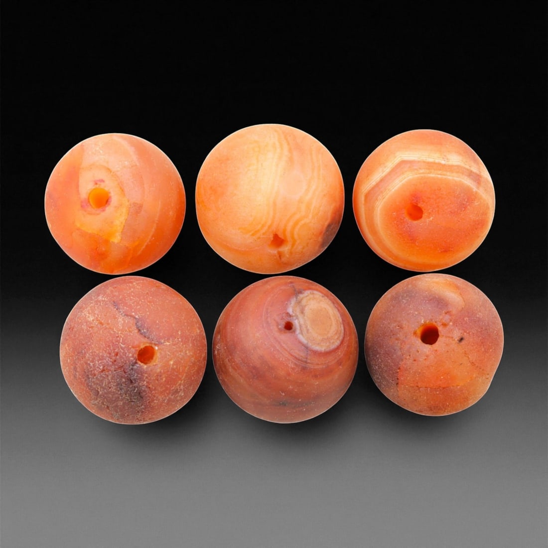 Antique Tibetan Carnelian Beads Collection, c. 18th-19th Century, 1.7-1.9cm, 29EL: This collection of antique Tibetan carnelian beads, dating to the 18th-19th century, exemplifies the spiritual and artisanal refinement of Himalayan lapidary traditions. Each bead, hand-shaped from na