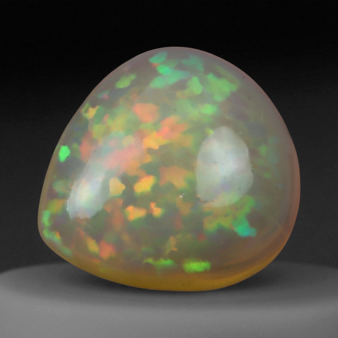 4.10 Carats Multi-Color Welo Opal Lot - Natural Ethiopian Stones, 57WE: This radiant group of Welo opals displays a mesmerizing interplay of color that dances across the surface with every shift of light. Electric flashes of green, orange, and red ripple through a translu