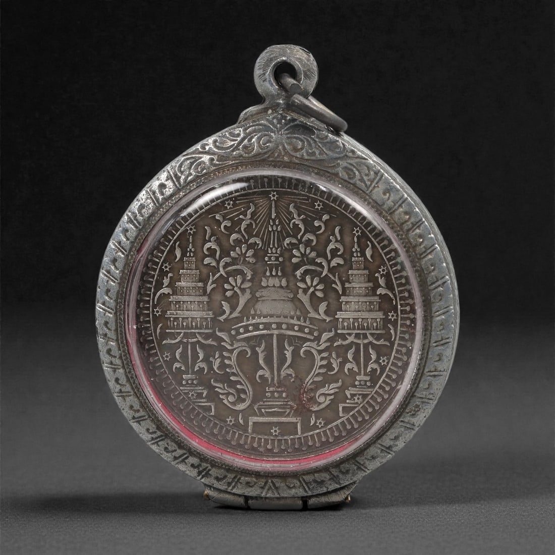 Buddhist Coin Amulet - Elephant Emblem & Royal Seal Pendant, 67C: This round pendant encloses a metal coin displaying an elephant emblem within a radiating wreath on one side, while the reverse bears a formal arrangement of tiered royal seals executed in balanced sy