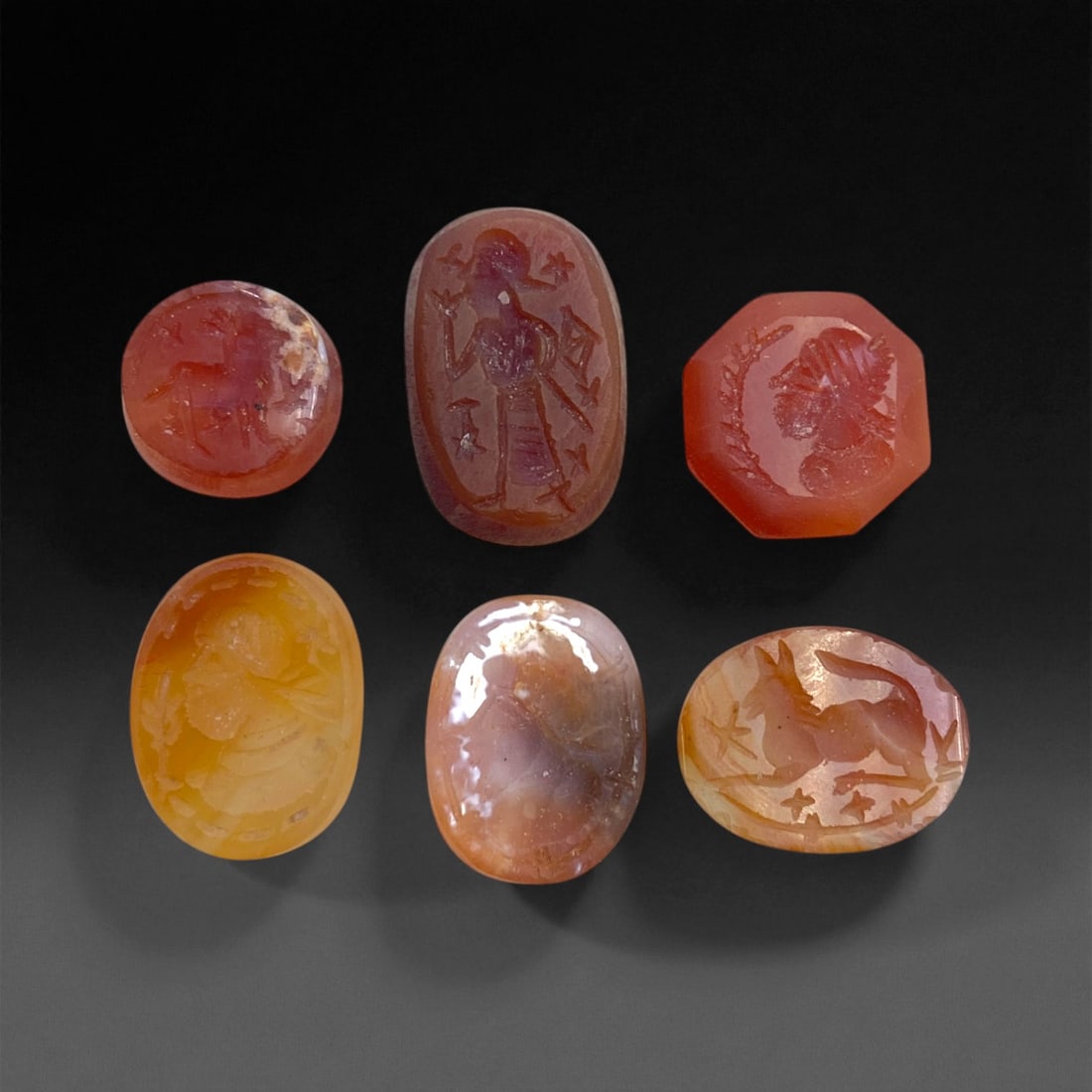 Ancient Sasanian Carnelian Intaglio Seals, c. 3rd-6th Century CE, 1.5-2 cm, 15 g, 5DD: This distinguished set of six engraved carnelian intaglio seals originates from the Sasanian Empire, one of the last great powers of the ancient Near East before the advent of Islam. The seals display