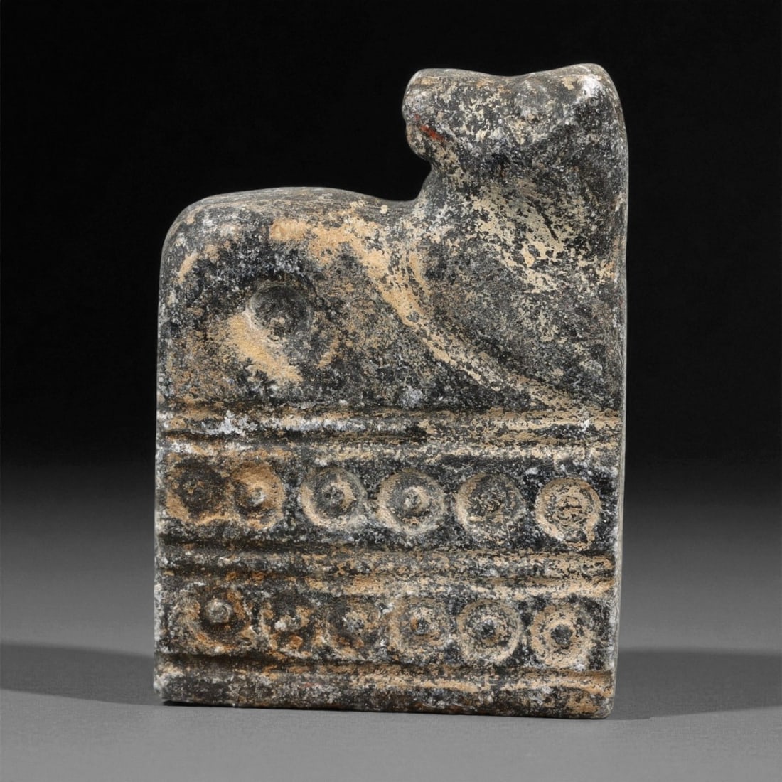 Ancient Indus Valley Schist Plaque with Feline Relief, c. 2500-2000 BCE, 4.4cm, 17ER: This finely carved schist plaque, measuring 4.4 cm in height, originates from the Indus Valley Civilization, circa 2500-2000 BCE. The piece depicts a stylized feline in low relief, rendered with confi