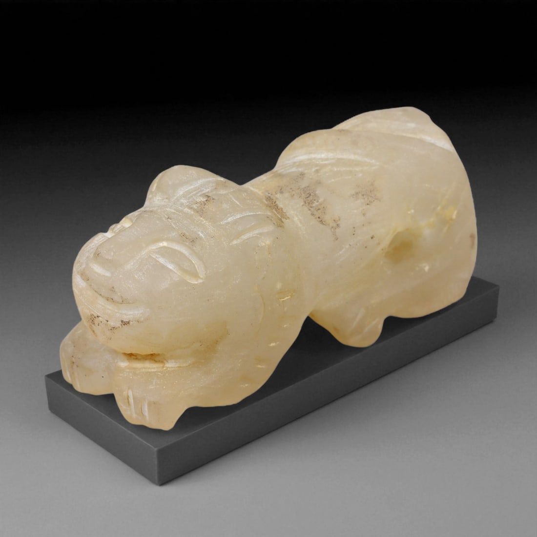 Ancient Bactrian Feline Amulet in Alabaster Stone, c. 2200-1800 BCE, 5 cm, 27BF: This compact amulet, carved in the form of a crouching feline, originates from the ancient Bactrian region-modern northern Afghanistan and southern Central Asia-during the Bronze Age. Crafted from fin
